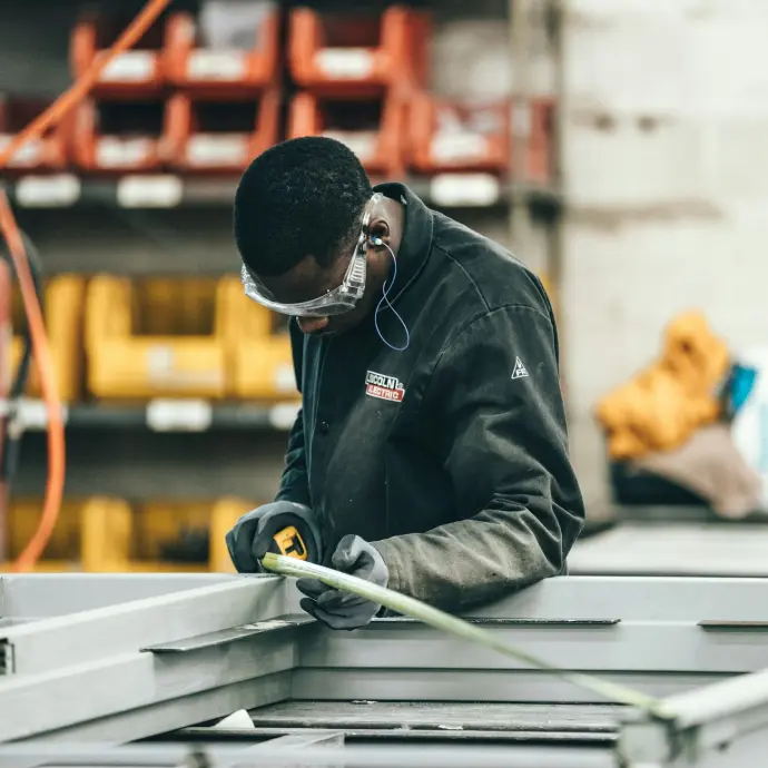 man wearing black jacket holding rod